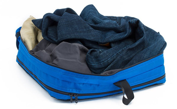 A change of clothes in an open Island (blue) Aether Large Aeronaut 45 Packing Cube all-fabric side up.